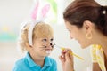 Mother and kids, family coloring Easter eggs Royalty Free Stock Photo