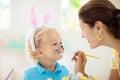 Mother and kids, family coloring Easter eggs Royalty Free Stock Photo