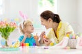 Mother and kids, family coloring Easter eggs Royalty Free Stock Photo