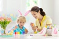 Mother and kids, family coloring Easter eggs Royalty Free Stock Photo