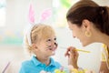 Mother and kids, family coloring Easter eggs Royalty Free Stock Photo