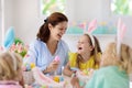 Mother and kids, family coloring Easter eggs Royalty Free Stock Photo
