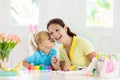 Mother and kids, family coloring Easter eggs Royalty Free Stock Photo