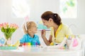 Mother and kids, family coloring Easter eggs Royalty Free Stock Photo