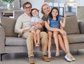 Mother, kids and father in a happy family portrait on sofa in a lovely home and enjoying quality time in the living room Royalty Free Stock Photo