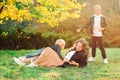 Mother and kids having fun outdoors. Fashionable family walking in autumn nature. Family, fashion and lifestyle Royalty Free Stock Photo