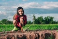 Mother and kids planting the tree on dirt on rice field and blue sky background Royalty Free Stock Photo