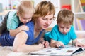 Mother and kids reading book at home Royalty Free Stock Photo