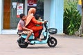mother and kids riding electric bike
