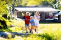 Mother and kids running outdoor at big house Royalty Free Stock Photo