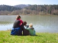 Mother with kids sitting by the lake Royalty Free Stock Photo