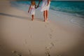 Mother and kids walking on beach leaving footprint in sand Royalty Free Stock Photo