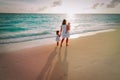 Mother and kids walking on beach leaving footprint in sand Royalty Free Stock Photo