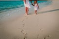 Mother and kids walking on beach leaving footprint in sand Royalty Free Stock Photo