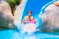 Mother and kids at water slide Royalty Free Stock Photo