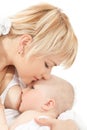 Mother kiss and breast feeding her baby girl