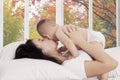 Mother kiss her baby in bedroom Royalty Free Stock Photo