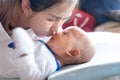 Mother kiss her baby infant son with love Royalty Free Stock Photo