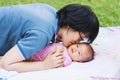 Mother kiss her baby at park Royalty Free Stock Photo