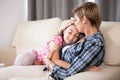 Mother kisses her daughter on the forehead Royalty Free Stock Photo