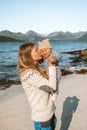 Mother kissing baby family lifestyle parent mom and child walking on the beach outdoor travel together in Norway Royalty Free Stock Photo