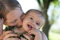 Mother kissing baby girl in her neck Royalty Free Stock Photo