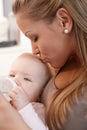 Mother kissing baby girl Royalty Free Stock Photo