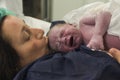 Mother kissing carefully her baby right after birth Royalty Free Stock Photo