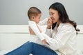 mother kissing hand of her infant baby on bed Royalty Free Stock Photo