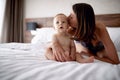 Mother kissing her child son on the bed Royalty Free Stock Photo