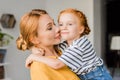 Mother kissing her daughter in cheek Royalty Free Stock Photo