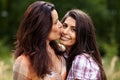 Mother kissing her daughter on the cheek Royalty Free Stock Photo