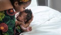 Mother kissing her son forehead, 2-month-old baby newborn Royalty Free Stock Photo