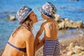 Mother, kissing her toddler child on the beach, sign kiss on his back Royalty Free Stock Photo