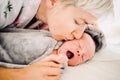 Mother kissing her newborn baby boy Royalty Free Stock Photo