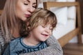 Mother is kissing his son. Mom and son. Happy mother`s day. Mother hugging her child at home Royalty Free Stock Photo