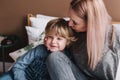 Mother is kissing his son. Mom and son. Happy mother`s day. Mother hugging her child at home Royalty Free Stock Photo