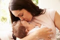 Mother Kissing Sleeping Baby Boy At Home Royalty Free Stock Photo