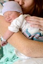 Mother kissing smiling newborn baby Royalty Free Stock Photo