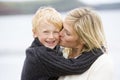 Mother kissing son at beach smiling Royalty Free Stock Photo