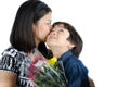 Mother kissong her son with flower Royalty Free Stock Photo