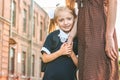 The mother leads the little girl student to the first grade hand in hand. Back to school. The beginning of the lessons. First day. Royalty Free Stock Photo