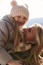 Mother lifting her daughter in the air outdoors, vertical Royalty Free Stock Photo