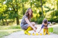 Mother and little adorable child in yellow rubber boots Royalty Free Stock Photo