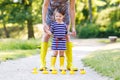 Mother and little adorable child in yellow rubber boots Royalty Free Stock Photo