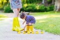 Mother and little adorable child in yellow rubber boots Royalty Free Stock Photo