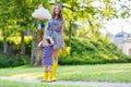 Mother and little adorable child in yellow rubber boots Royalty Free Stock Photo