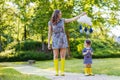 Mother and little adorable child in yellow rubber boots Royalty Free Stock Photo