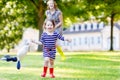 Mother and little adorable child in yellow rubber boots Royalty Free Stock Photo