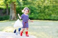 Mother and little adorable child in yellow rubber boots Royalty Free Stock Photo